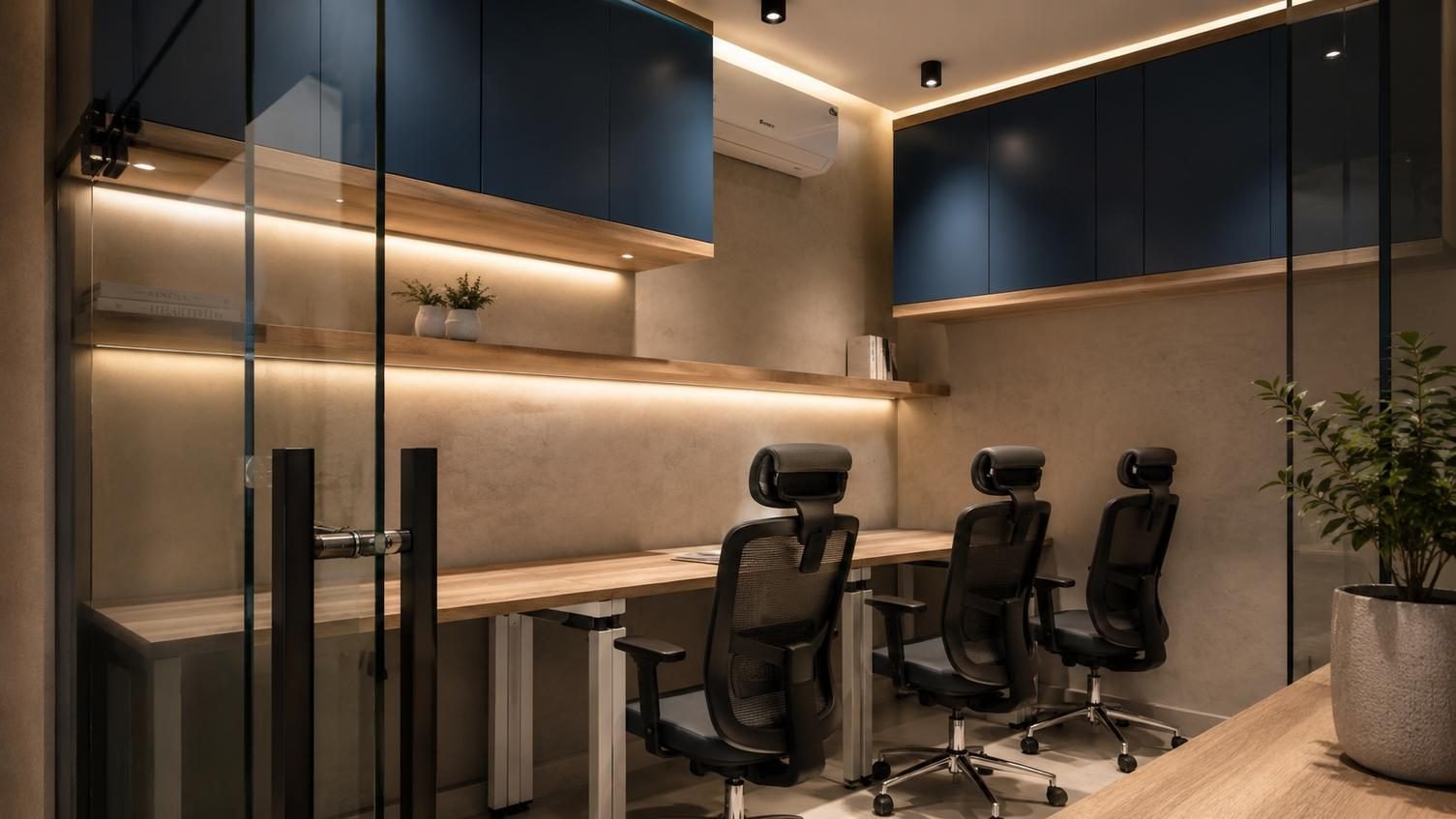 Glass-fronted meeting room with black metal frames and navy cabinetry, fitted by Designation for Best Tech in Al Khobar