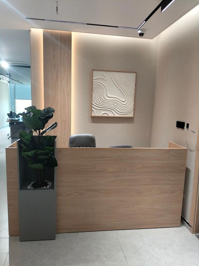 Oak reception desk and backlit wall as built for Hixagone in Al Khobar