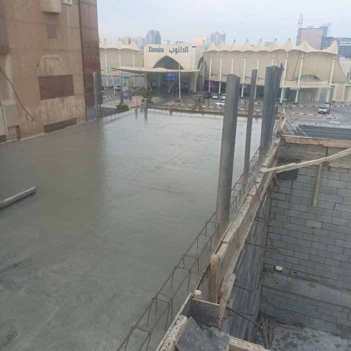 Freshly poured concrete slab with starter bars on a building site